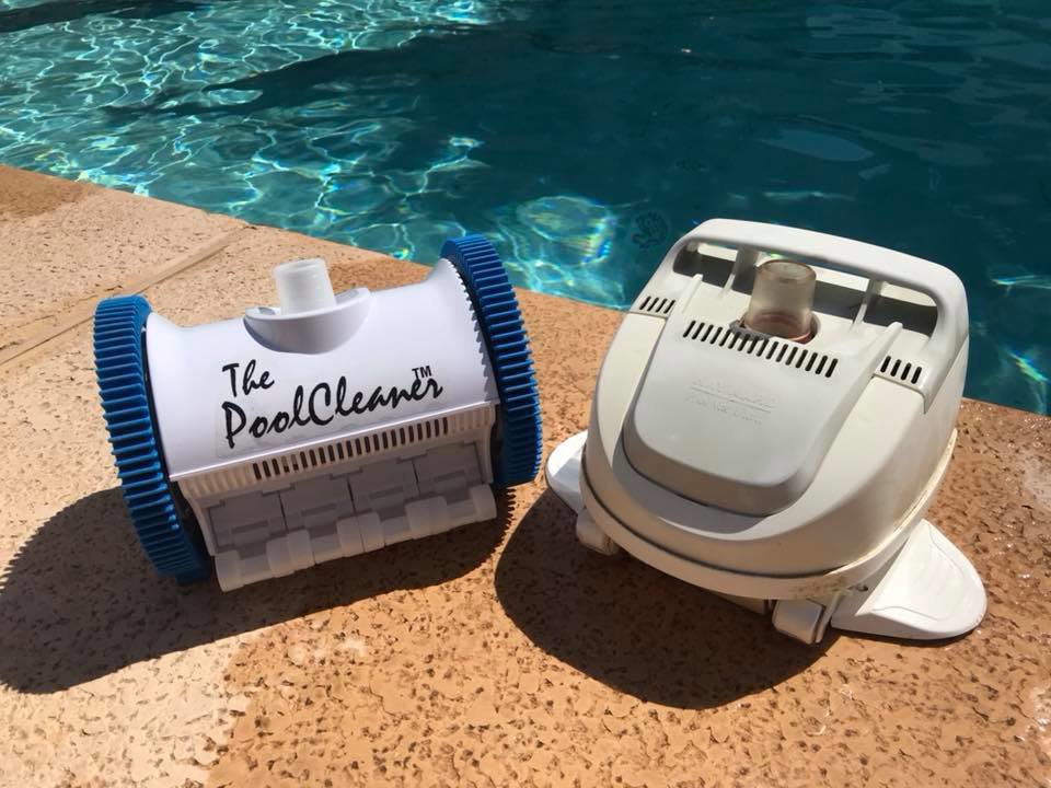 Two pool cleaning robots on the edge of a sparkling pool by Classic Pool Service in Surprise, AZ