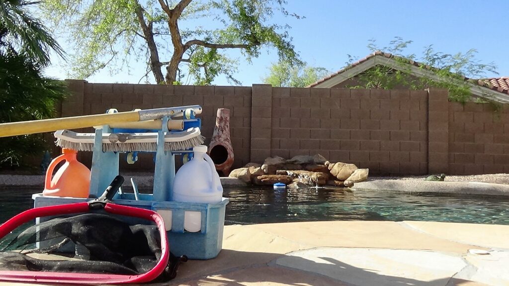A pool cleaning tool caddy filled with brushes, chemicals, and nets, ready for service by Pool Rescuers LLC in Gilbert, AZ.