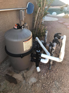 Outdoor pool equipment including a large filter and pump system by Classic Pool Service in Surprise, AZ
