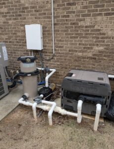 Outdoor pool equipment, including a Hayward heater and filter, installed by Alabama Pool Kings in Madison, AL.