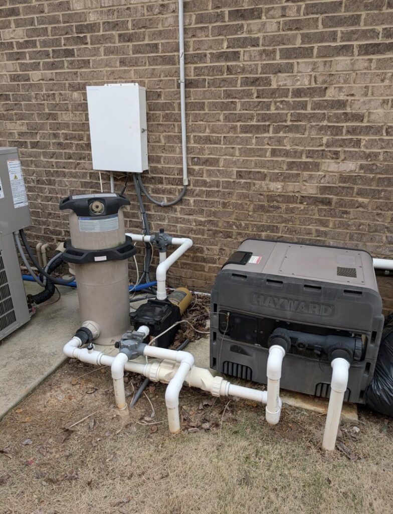 Outdoor pool equipment, including a Hayward heater and filter, installed by Alabama Pool Kings in Madison, AL.