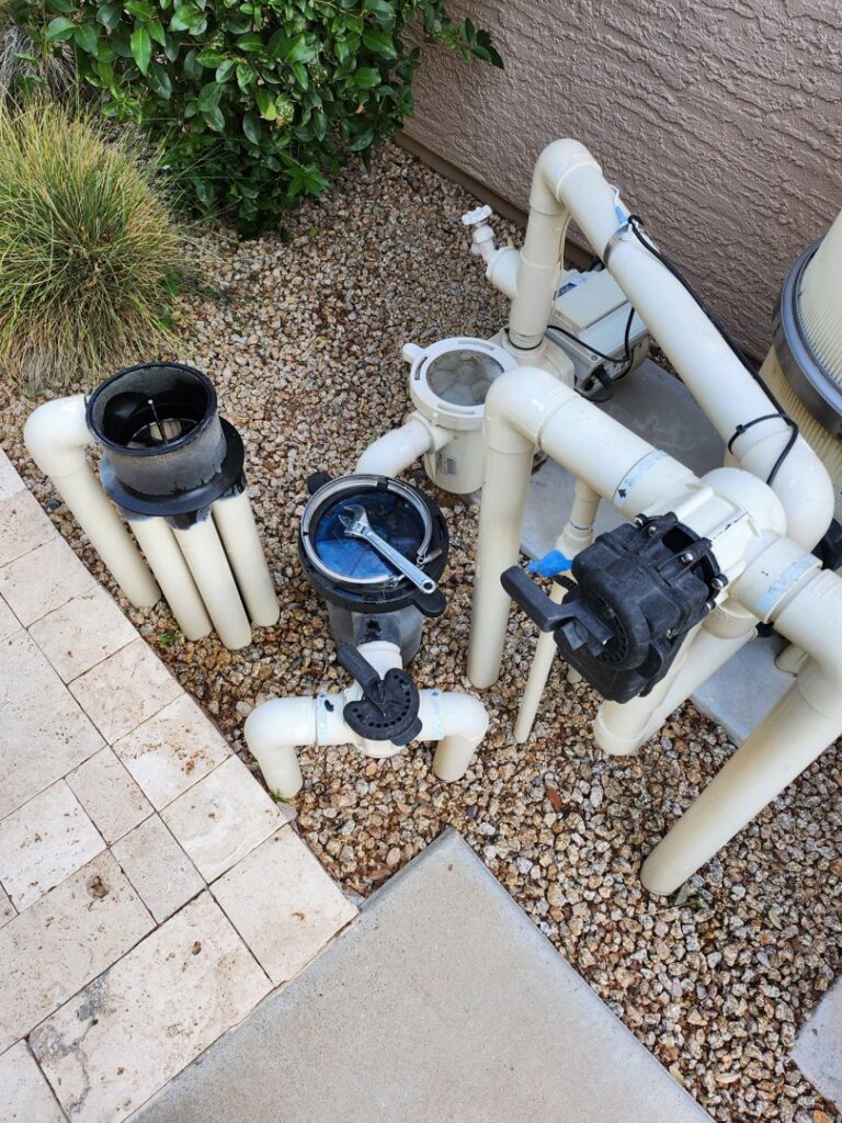 Pool equipment being serviced with a wrench by Blue Square Manufacturing, LLC, providing expert pool cleaner services in Chandler, AZ.