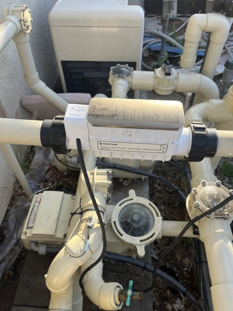 Close-up of pool equipment, including a salt chlorine generator, maintained by Good Guy Pool Service in Moreno Valley, CA.