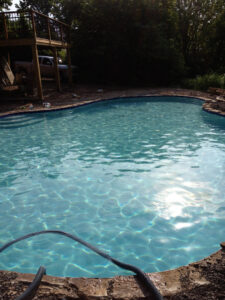 A residential pool being filled or drained as part of a cleaning service by A-Grade Pools in Knoxville, TN.
