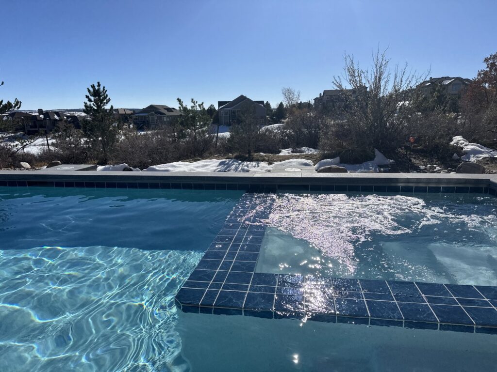A beautiful pool with an integrated bubbling spa, a completed project by Wetworks Pool and Spa in Englewood, CO.