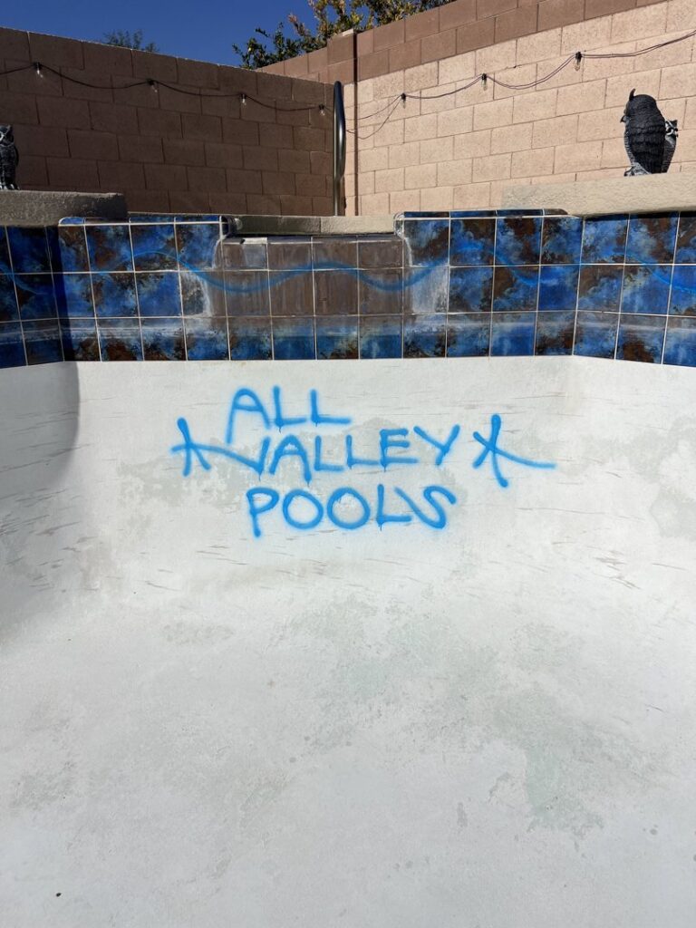 The interior of an empty pool marked with 'All Valley Pools' during a construction or renovation project in Avondale, AZ.
