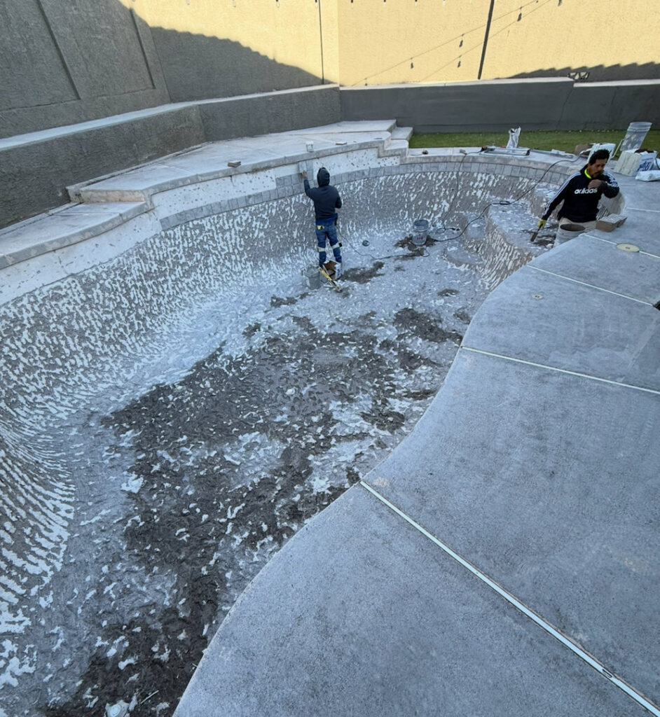 Pool contractors applying plaster during a new pool installation or renovation by All Valley Pools in Avondale, AZ.