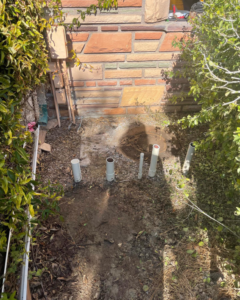 New pool plumbing pipes installed in the ground, indicating construction or repair work by Prime Pool Care in Satellite Beach, FL.