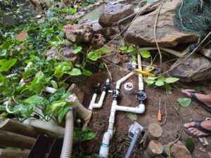 Pool plumbing repair in progress by All N One Pools,LLC in Lafayette, LA, showing exposed pipes and valves.