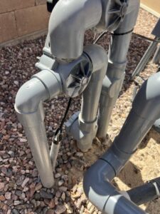 Close-up of pool plumbing and valves, part of the system maintained by Classic Pool Service in Surprise, AZ