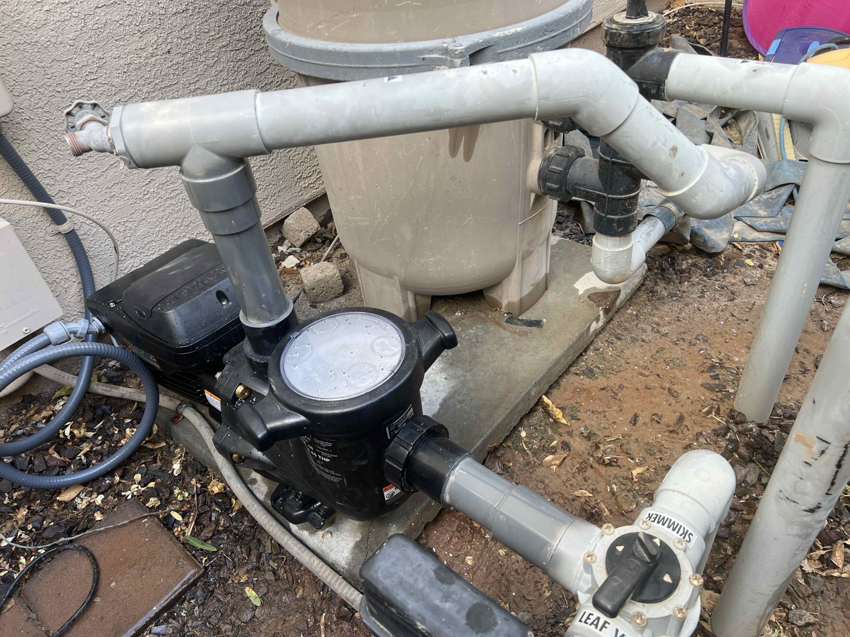 A close-up view of a pool pump and filter system maintained by Pool Pals in Franklin, MA.