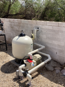Servicing a pool pump and filter system by Up Keep Pool & Spas for clean water in Tucson, AZ.