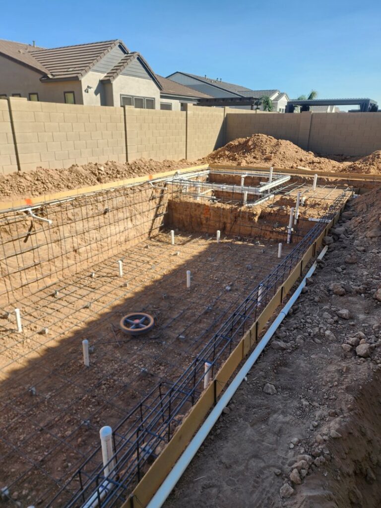 Pool construction showing rebar framework and plumbing installation by EZ POOL Solutions in Tucson, AZ