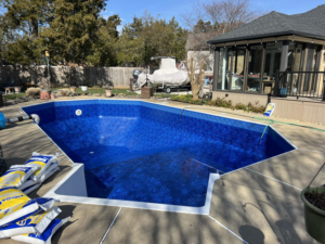 Pool renovation in progress with chemical bags on the deck by Pipeline Pools Inc. in Virginia Beach, VA.