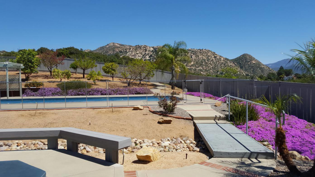 A professionally installed pool safety fence surrounding a backyard pool by Baby Guard Pool Fence Los Angeles, CA
