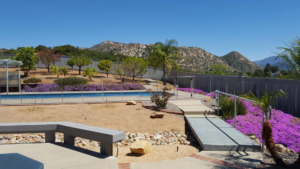 A professionally installed pool safety fence surrounding a backyard pool by Baby Guard Pool Fence Los Angeles, CA