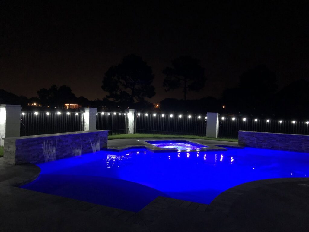 A pool service technician from Gayle Force Pools cleaning a residential swimming pool in Lake Charles, LA