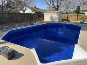 Pool service toolbox next to an empty pool with a new liner by Pipeline Pools Inc. in Virginia Beach, VA.