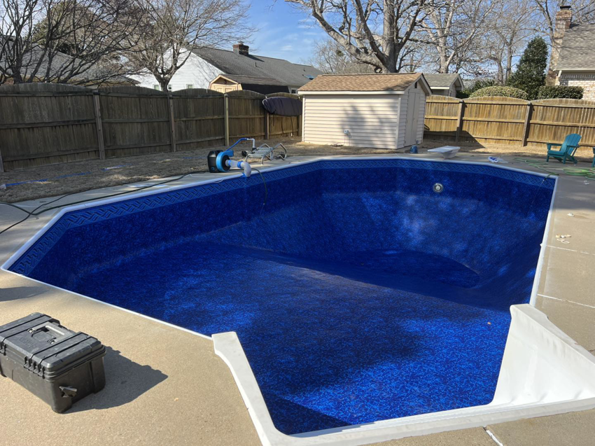 Pool service toolbox next to an empty pool with a new liner by Pipeline Pools Inc. in Virginia Beach, VA.