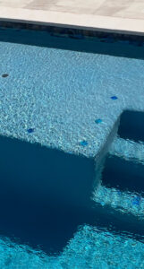 Close-up of beautifully tiled pool steps and clear water, showcasing quality craftsmanship by All Valley Pools in Avondale, AZ.