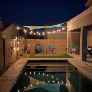 A Classic Pool Service technician working on pool electrical controls and equipment in Surprise, AZ