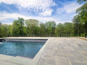 A modern cable railing fence installed around a swimming pool area by H&M Fence, LLC in Norwalk, CT.