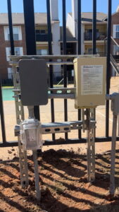 Poolside electrical outlet and timer installed on a fence by Red Earth Electric LLC in Oklahoma City, OK.