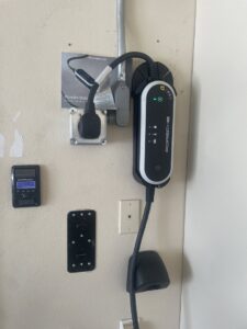 A Porsche electric vehicle charger professionally installed on a wall by Steve Cavenee Electric in Orange, CA.