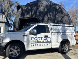 A Port City Pest Control truck parked in front of a residential home in Summerville, SC, ready for service.