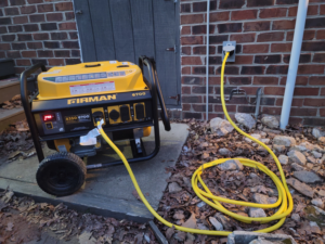 A portable generator connected to an outdoor electrical outlet by Ethan Parks Electrical Contractor LLC in Burkeville, VA.