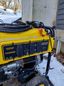 A yellow portable generator installed outside, ready for use by Eastern Electrical Contractors in Waterbury, CT.