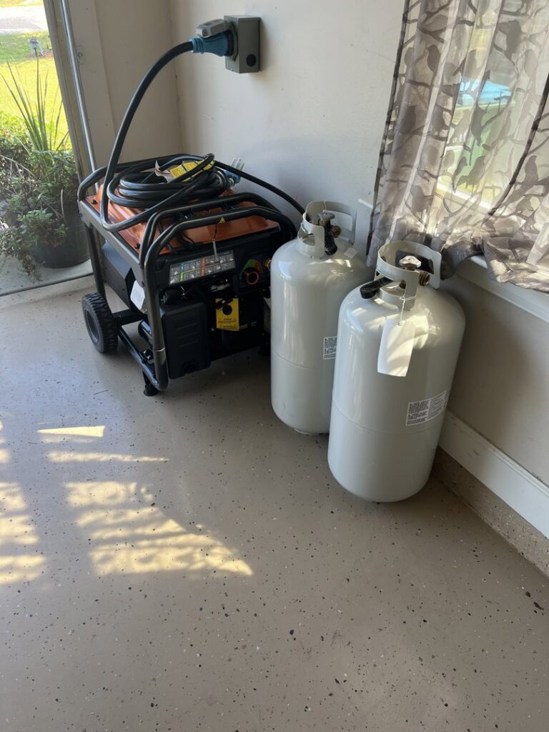 A portable generator plugged into an outdoor outlet with propane tanks, demonstrating backup power solutions by Weston Trawick, Inc. in Tallahassee, FL.