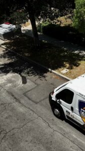 A Positive Electricians service van parked on a street in Van Nuys, CA, ready for a job.