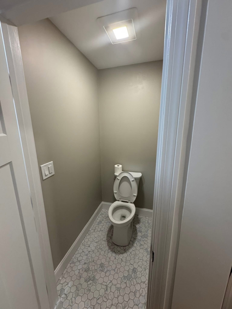 A newly installed ceiling exhaust fan with light and wall switch in a powder room by P. Cruz Electric LLC in Springfield, MA.