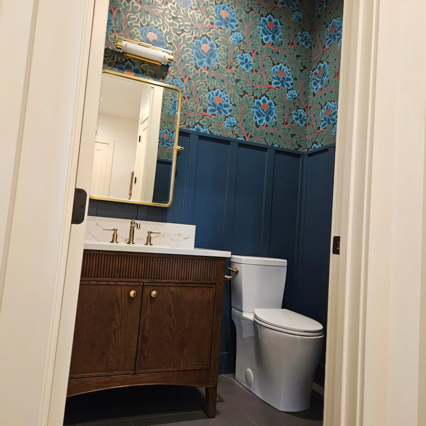 A newly installed wall-mounted light fixture in a modern powder room by Jam Electric in Albuquerque, NM.