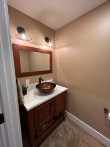New wall sconce lighting installed in a powder room by Nuts And Volts Electric LLC in Farmington, NH.