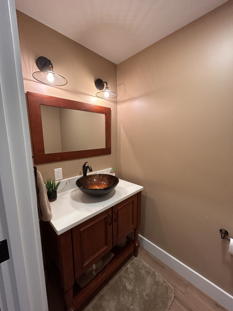 New wall sconce lighting installed in a powder room by Nuts And Volts Electric LLC in Farmington, NH.