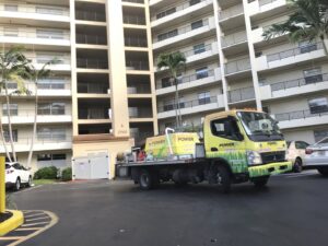 A PowerX Pest Control of South Florida truck parked at an apartment building in Miami, FL.