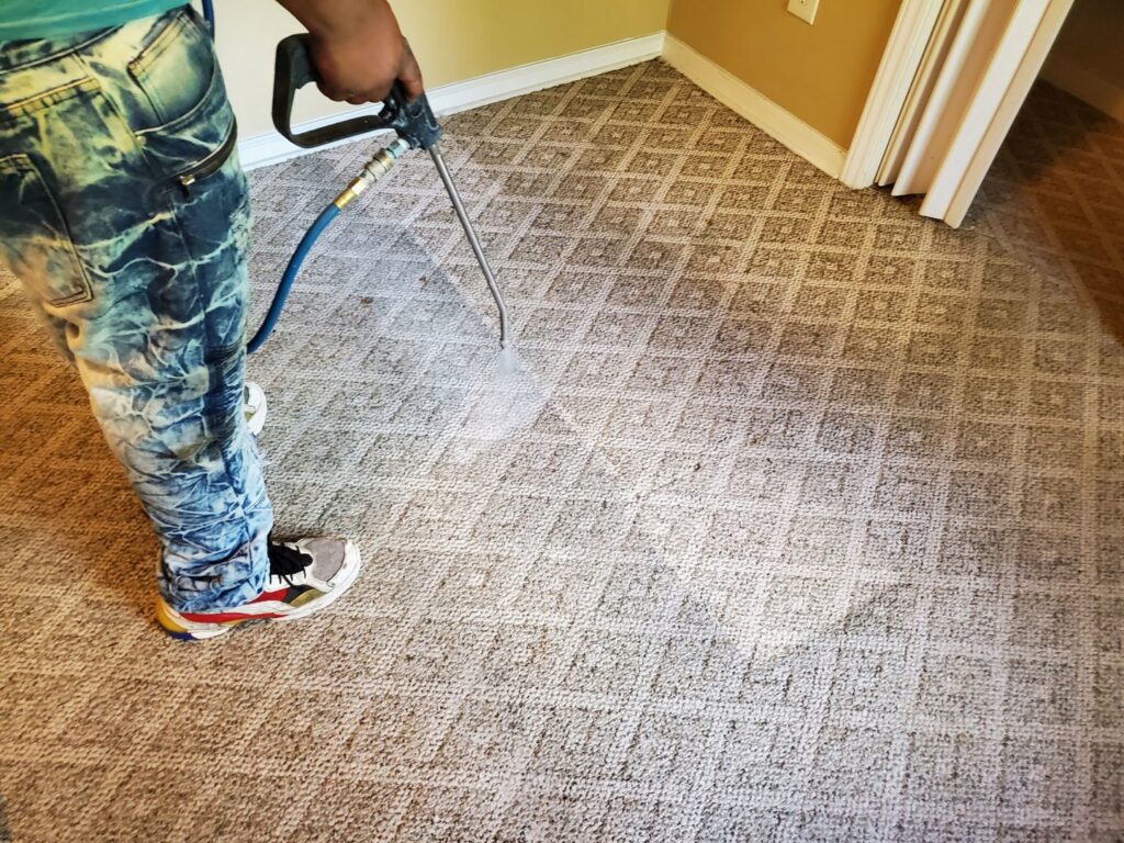 A technician pre-spraying a patterned carpet as part of the cleaning process by Spot On Carpet Cleaning of Columbia, SC.
