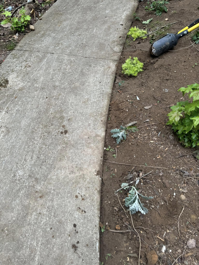 Preparing a garden bed for planting new shrubs and flowers by D&L lawn care service in Hoover, AL