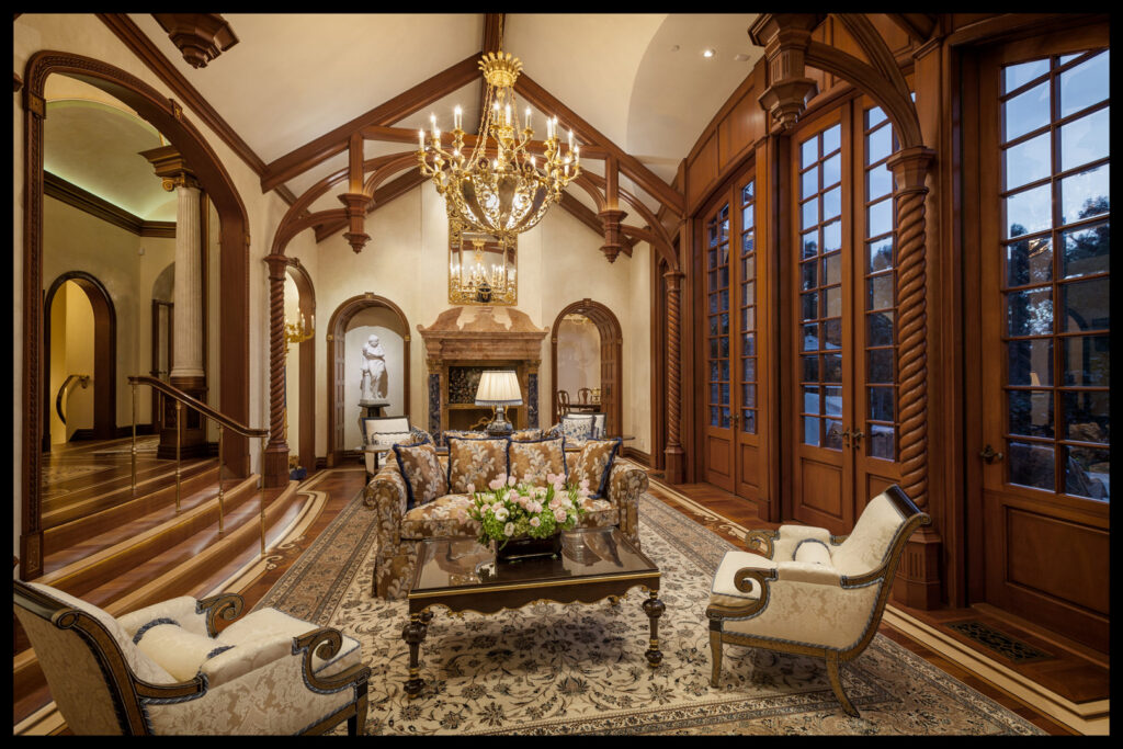 Two individuals presenting a large, intricately patterned rug, showcasing services from Ko-Z-Craft in Los Angeles, CA.