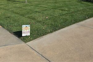 A Pro Pest Solutions sign placed on a residential lawn, indicating pest control services by Nebraska Pro Turf & Pro Pest Solutions in Omaha, NE.