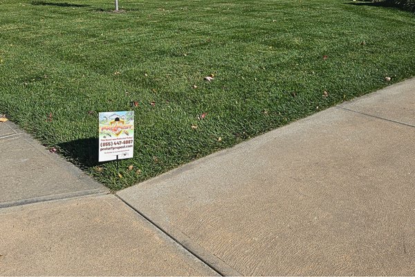 A Pro Pest Solutions sign placed on a residential lawn, indicating pest control services by Nebraska Pro Turf & Pro Pest Solutions in Omaha, NE.