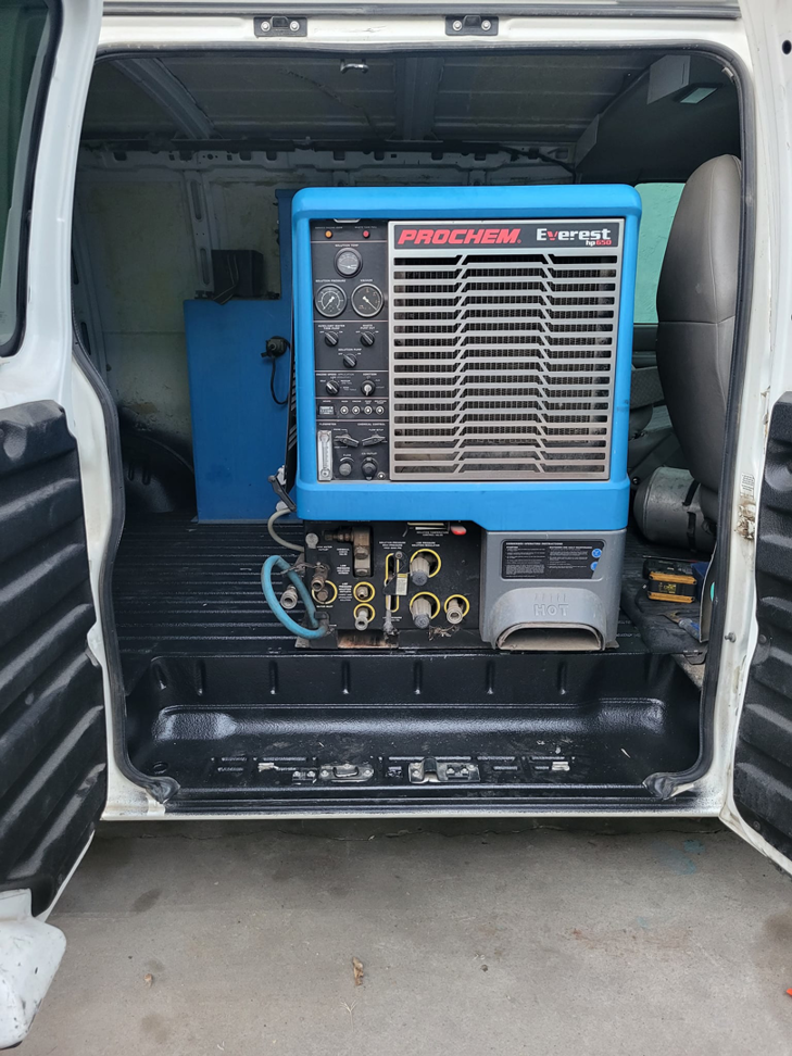 A Prochem Everest truckmount carpet cleaning machine installed in a service van for Delmac Products Truckmount Service in Bakersfield, CA.