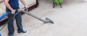 A professional performing carpet cleaning service with a machine at Action Carpet Cleaning & Restoration in Norman, OK
