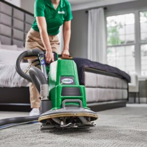 A professional cleaning a bedroom carpet with a Chem-Dry machine for Veterans Chem-Dry Music City in Nashville, TN.