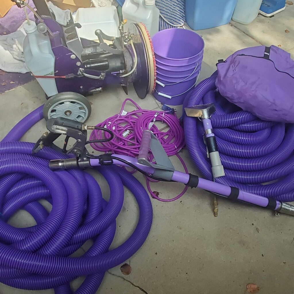 Professional carpet cleaning equipment, including hoses and machines, ready for a job by Royal Carpet & Upholstery Cleaning in Lincoln, NE.