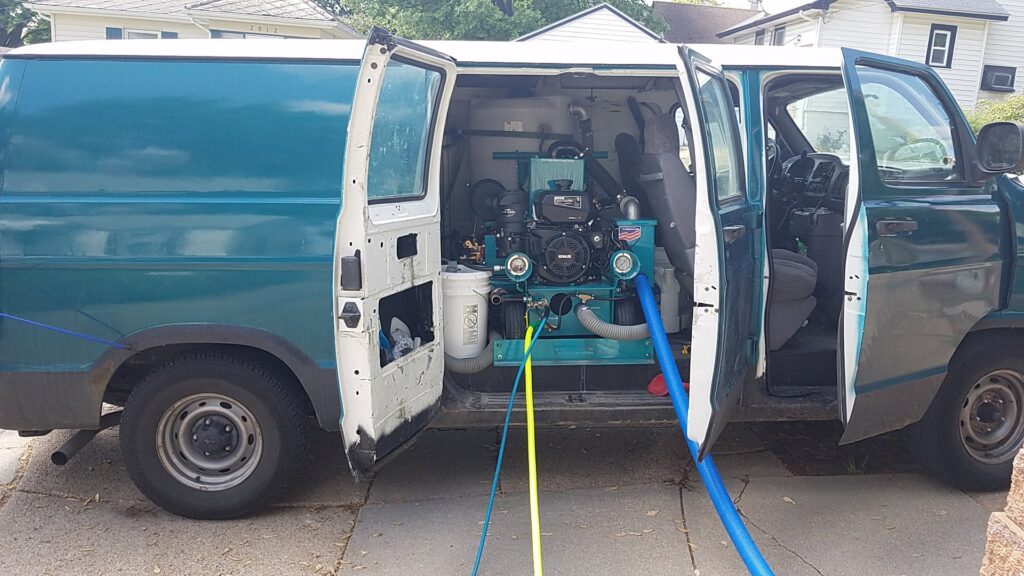 Professional carpet cleaning equipment and hoses extending from a service van for Inspection Ready LLC in Bellevue, NE.
