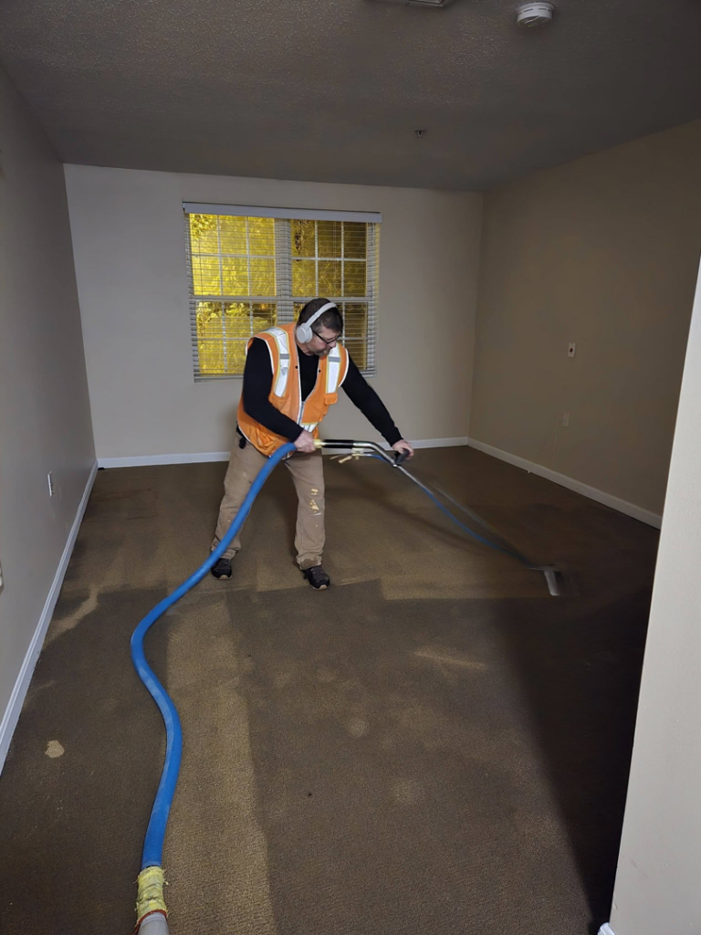 A professional cleaning carpet in an empty room by Aardvark Dean Of Clean in Nashua, NH.