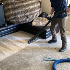 A professional from Jetsupercleancarpet performing carpet cleaning with a machine in a home in San Antonio, TX.